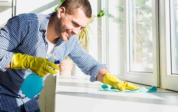 man wiping the countertop Cleaning Bee residential cleaning